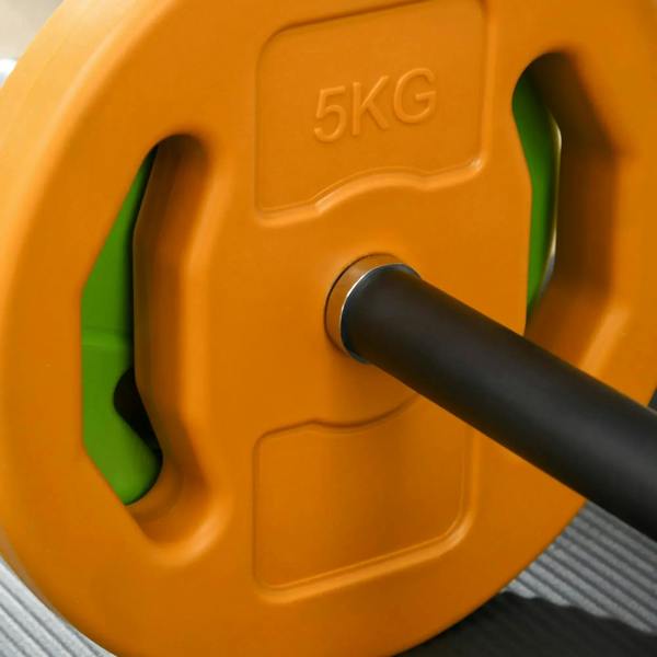 Orange 5KG weight plate with green inserts on a black barbell bar