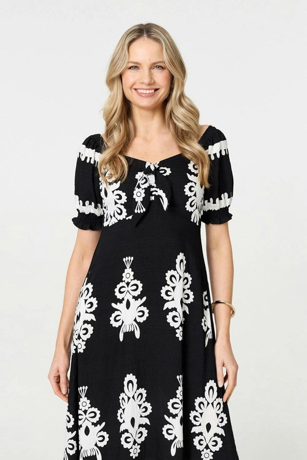 Black | Printed Puff Sleeve Tie Front Midi Dress : Model is 5'10"/178 cm and wears UK10/EU38/US6/AUS10
