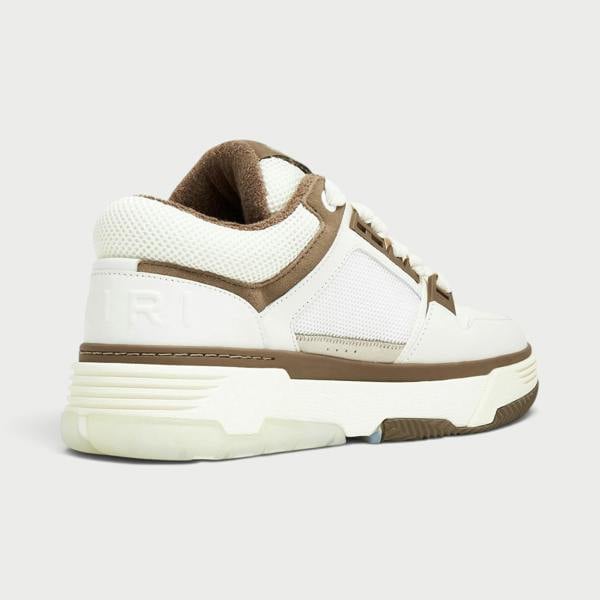 Supplied Fashion AMIRI MA-1 low-top sneakers in white and brown leather with a chunky rubber sole and mesh details.