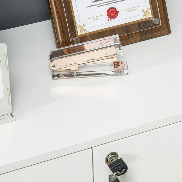 White cabinet door top corner with lock hardware and a key inserted