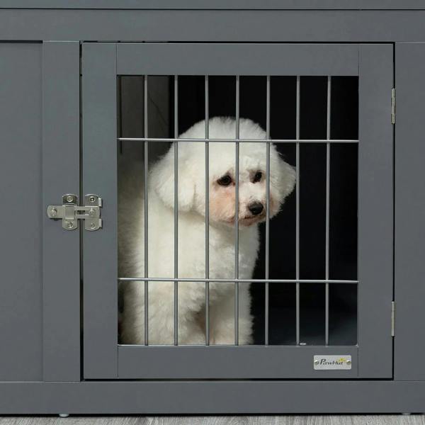 Grey dog crate door with wire bars and safety latch, small dog behind the gate