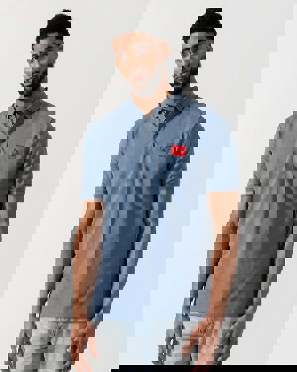 Model wearing HUGO Dereso222 Mens Cotton Piqué Slim-Fit Polo Shirt with Logo Label in Open Blue 496 - Main