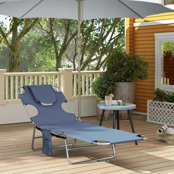Grey folding beach chaise lounge with head pillow, side pocket, and arm cutouts.