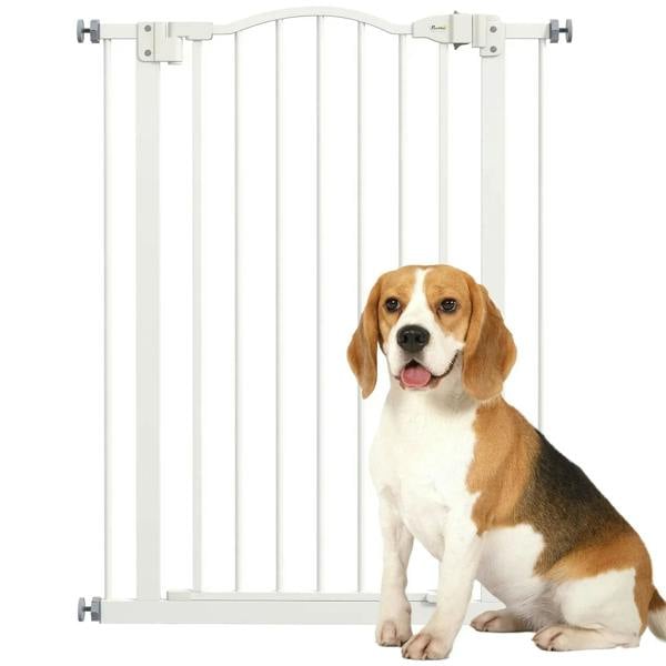 White pressure-fit dog gate with vertical bars and curved top, installed in doorway