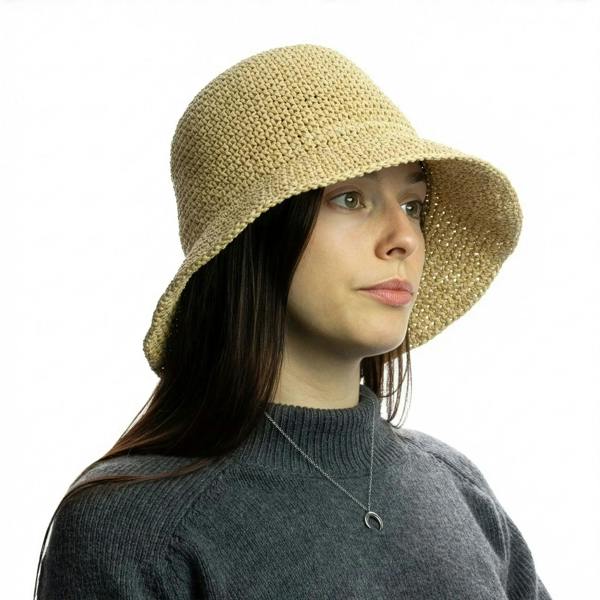 Natural beige straw floppy sun hat on model with wide brim and textured weave