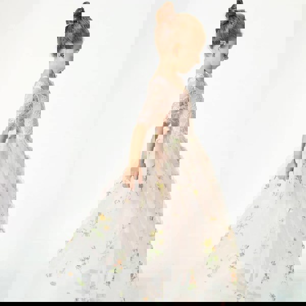 little girl dancing in pink embroidered dress