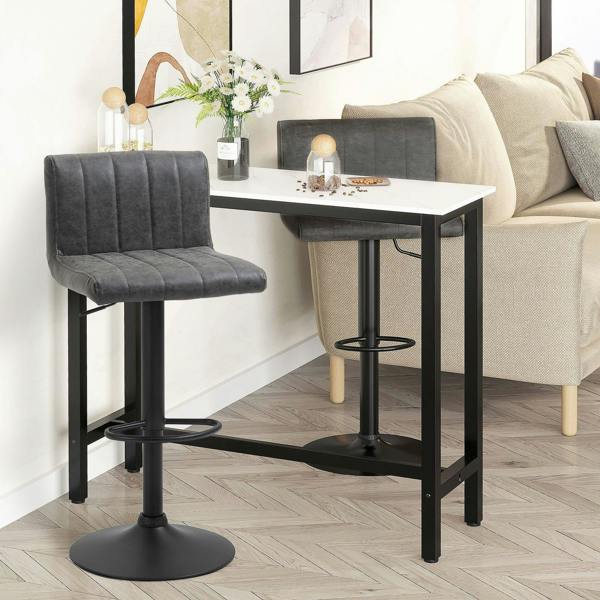 Grey upholstered swivel barstool beside a dining counter with black footrest and base