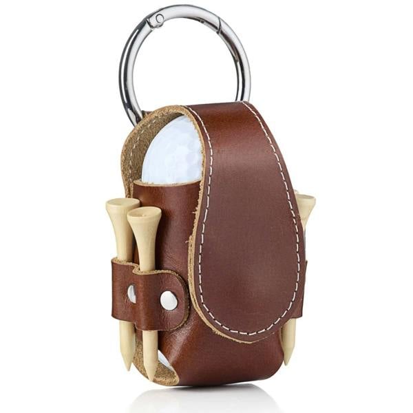 A brown leather golf ball pouch with white stitching, holding a white golf ball and wooden golf tees, featuring a silver metal carabiner clip against a isolated white background.