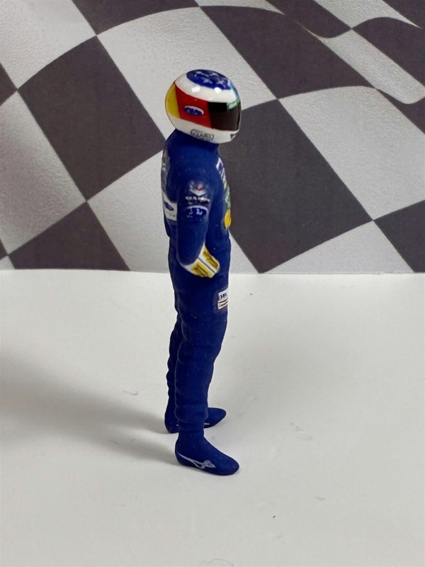 a toy figure of a race car driver
