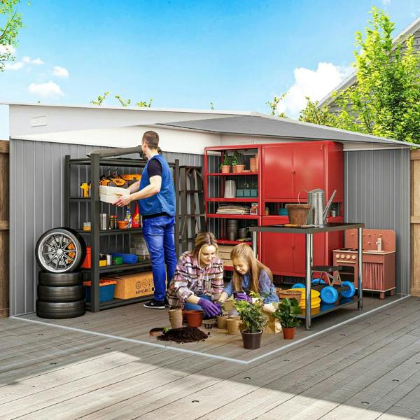 Green and gray metal storage shed with double sliding doors open for yard tools