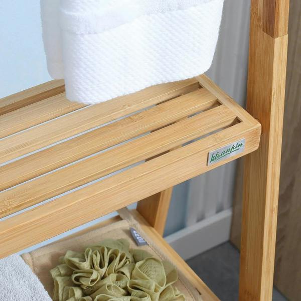 Bamboo towel rack shelf with slatted wooden surface and folded towels on lower level