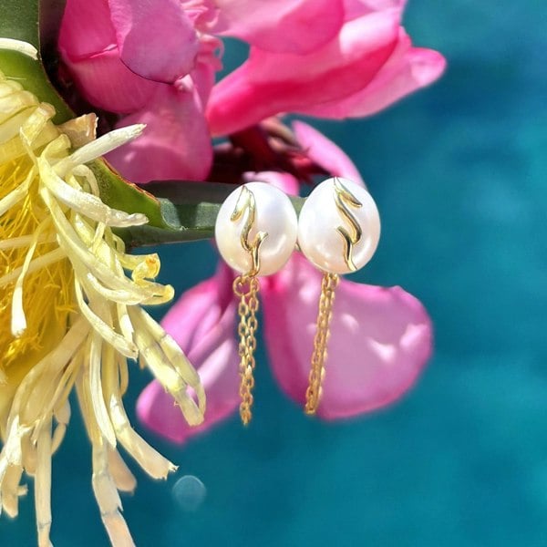 Unique and modern pearl studs by LENAE London with gold chains.
