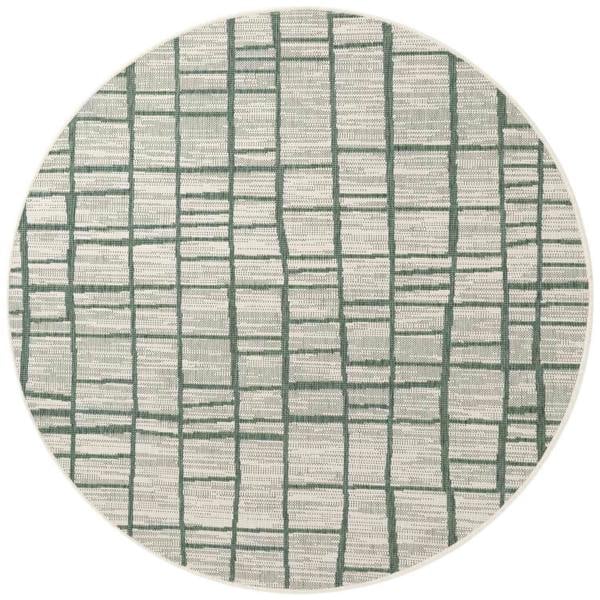 Round rug with green line pattern on a white background
