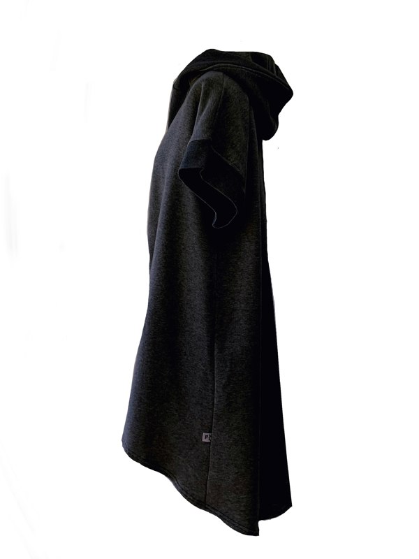 This is the side view of a black longline brushed fleece shrug with a hood set against a white background.