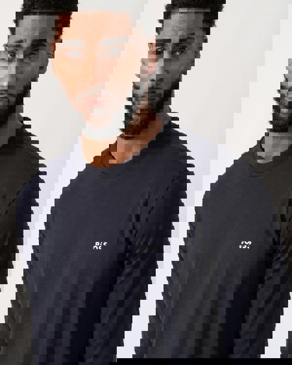 close up shot of a model wearing a BOSS Green Tee Mens Stretch-Cotton T-Shirt with Contrast Logo in Dark Blue