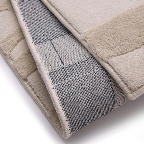 Close-up of a textured rug with a checkered pattern on a white background