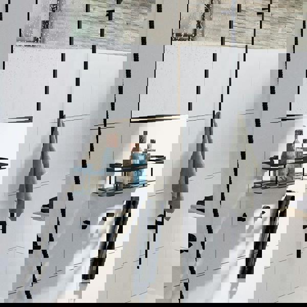 Three matt black towel hooks on bathroom wall