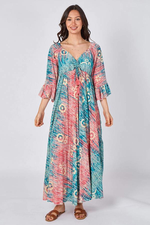 Woman wearing a colorful patterned dress on a white background