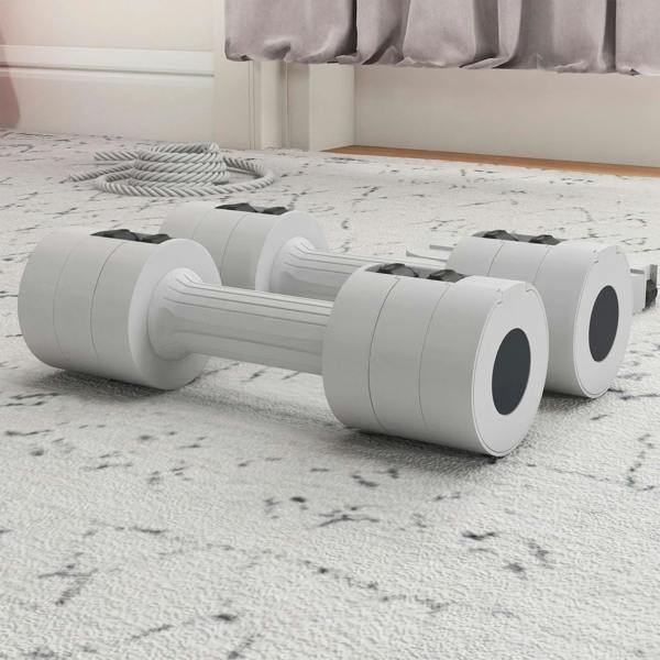 White adjustable dumbbells lying on the floor with round weight ends and handle