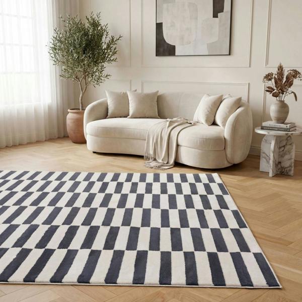 Living room with a white sofa, striped rug, and decorative elements.