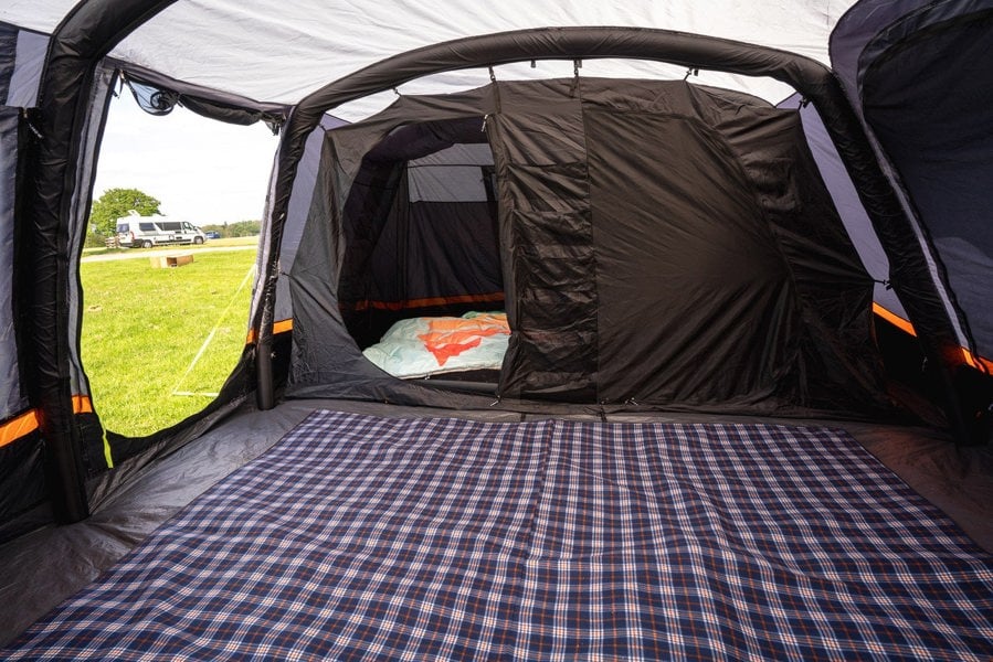 The spacious interior of the Discovery 6 Berth Inflatable Tent with a carpet