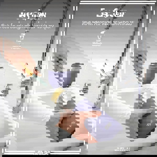 A hand scrubs a travel flask with a brush under a running kitchen faucet. Text: Easy Clean Crevice free design makes hand washing easy. Handwash. Travel Flask.