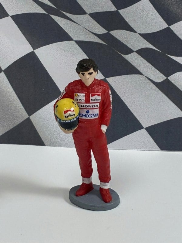 a toy figurine of a man holding a ball