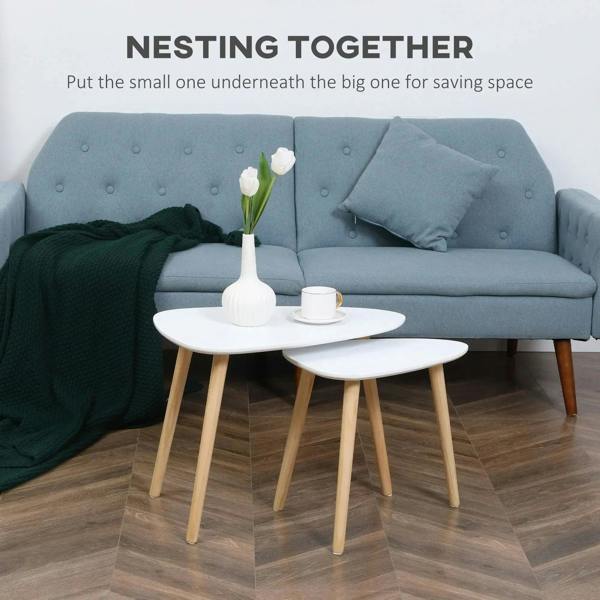 Pair of white nesting tables with light wood legs and rounded tabletop edges