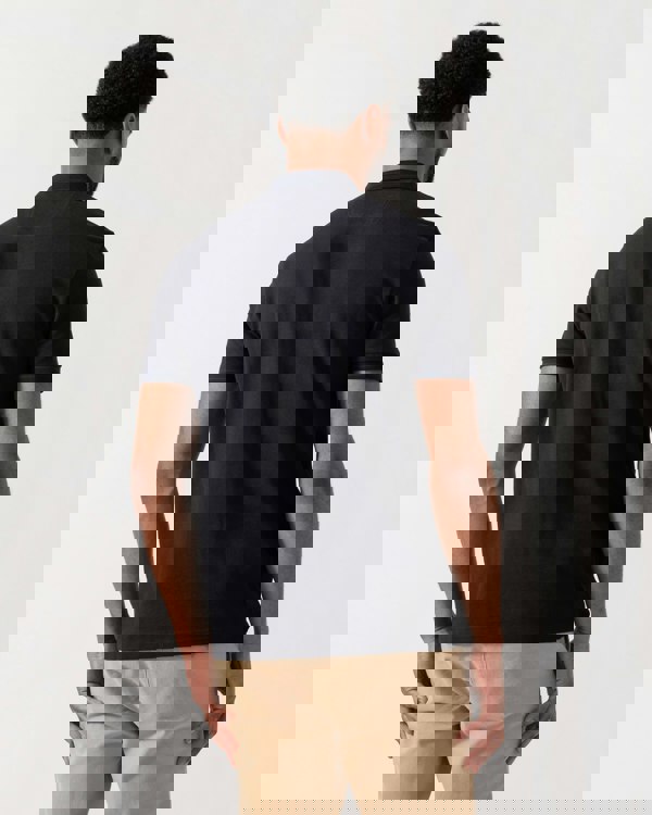 Model wearing BOSS Green Mens Paddy Cotton-Piqué Polo Shirt with Contrast Logo in Dark Blue 408 - back