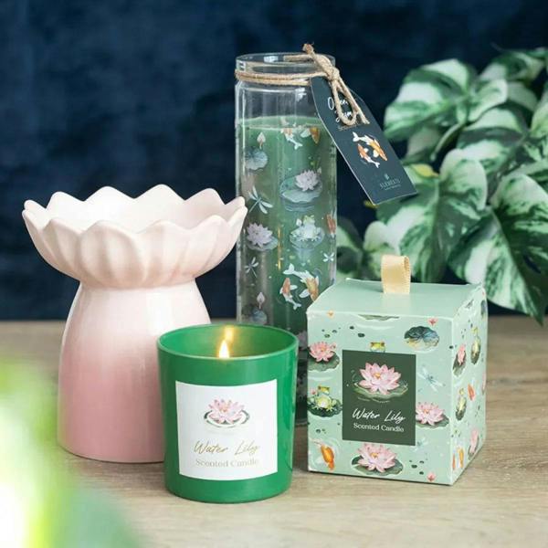 Green glass tube scented candle with burning wick and koi-lotus pond print