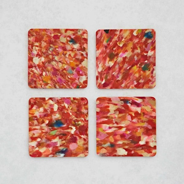 Set of 4 red and orange square recycled plastic coasters on a white surface.