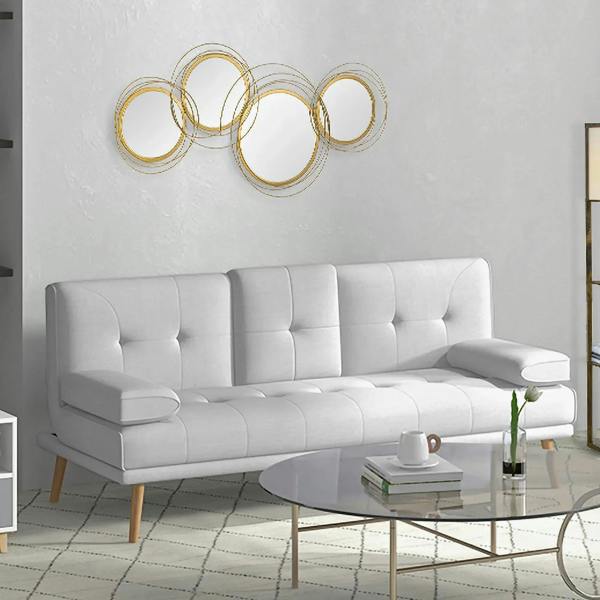 Gold-tone metal wall mirror set with five circular ring frames above a white sofa