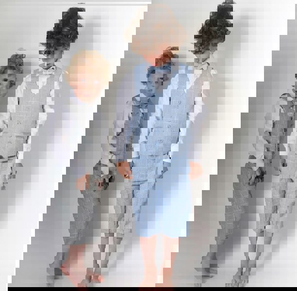 2 boys playing in suits