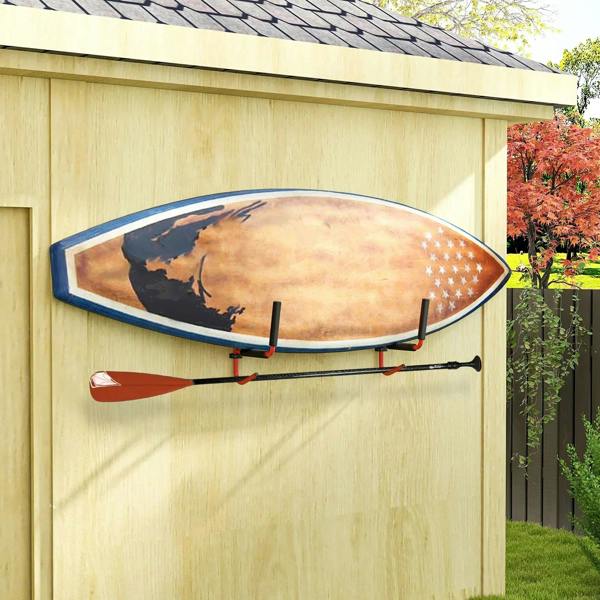Red wall-mounted kayak/canoe storage rack holding a decorated kayak with black padded ends