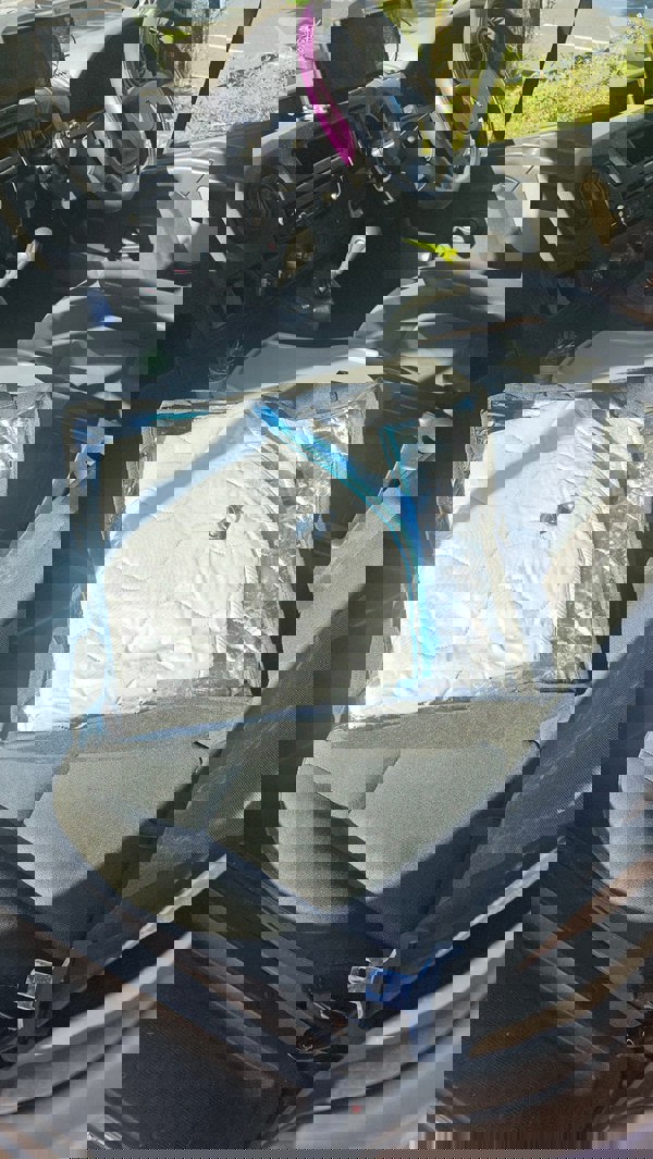 Image of Internal Thermal Blind Set (Renault Master, Vauxhall Movano, Nissan Interstar/NV400) in storage bag on passenger van seat.