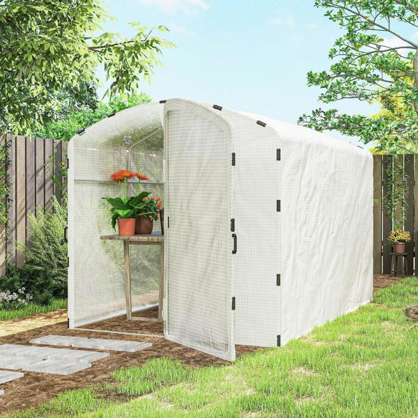 Walk-in greenhouse with white PE cover, covered sides and front door in a yard