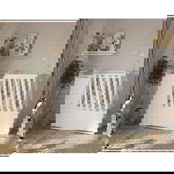 Cot on display in a modernly decorated nursery room.