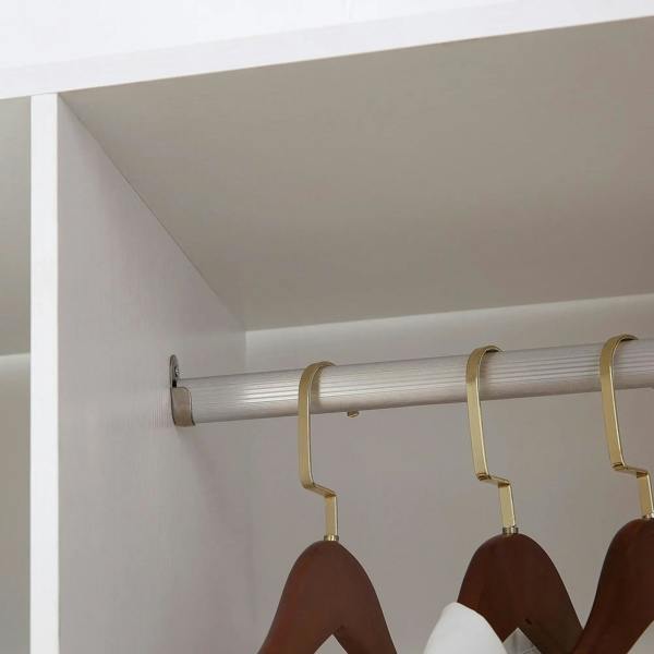 Metal hanging rod with hooks and brown hangers inside white wardrobe