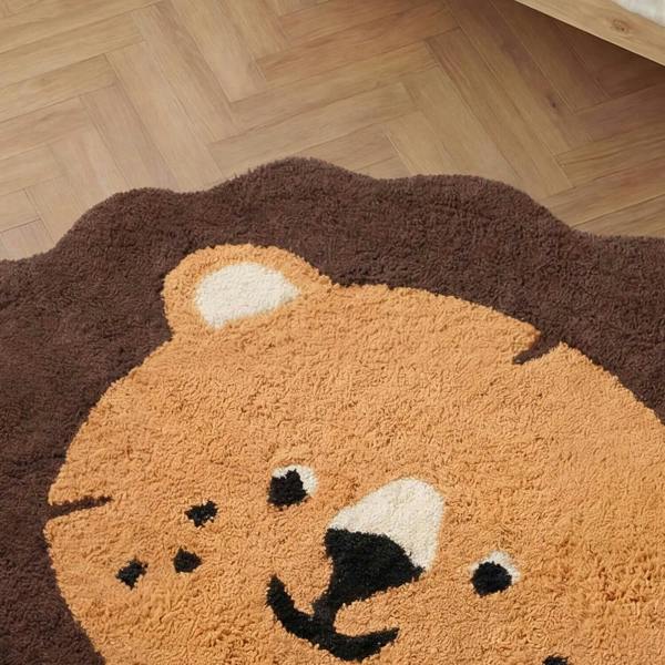 Round rug with a bear face design on a wooden floor