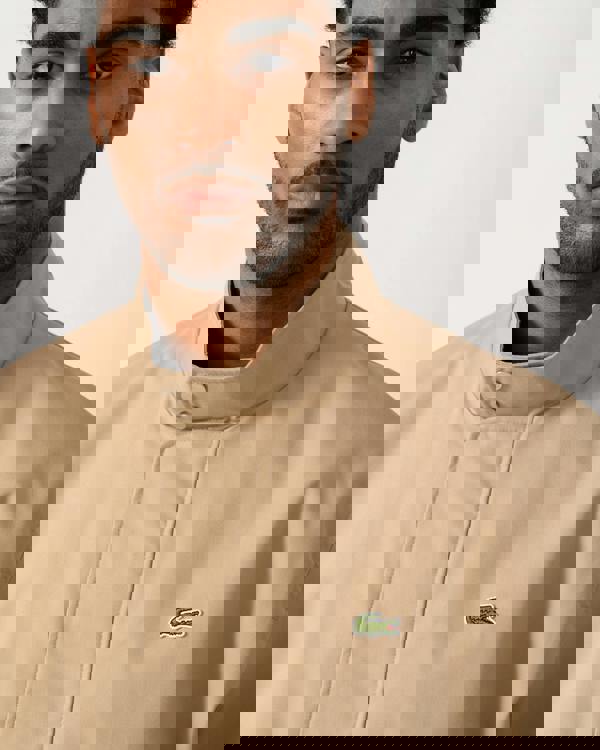 collar detail shot of a Model wearing a Lacoste Lightweight Water-Repellent Twill Mens Harrington Jacket in Viennese 02S