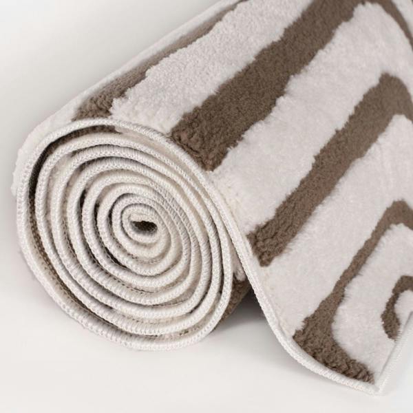 Rolled-up brown and white striped rug on a light gray background