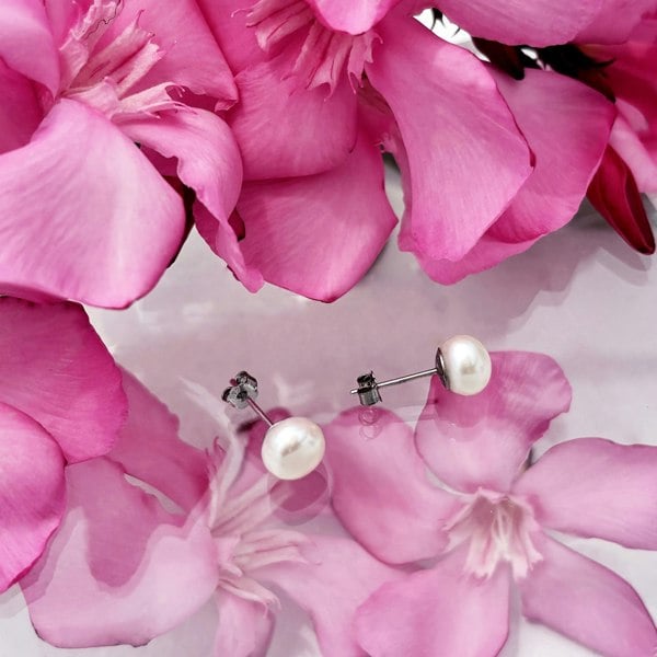 Small pearl studs with steering silver posts handcrafted by LENAE London.