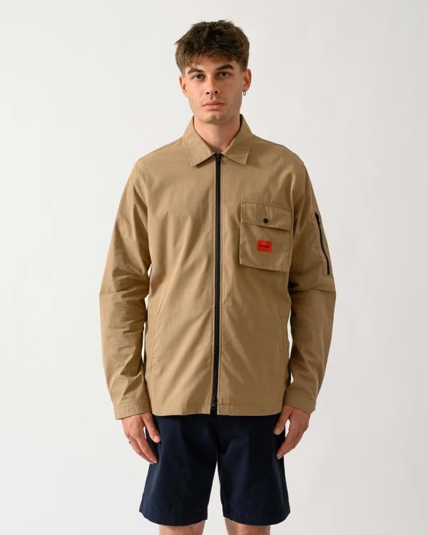 model wearing a HUGO Emmond Mens Zip Overshirt in Beige Overflow 928