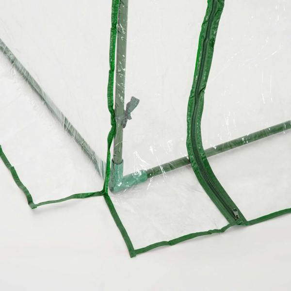 Clear PVC tunnel greenhouse corner with green frame joints and cross braces