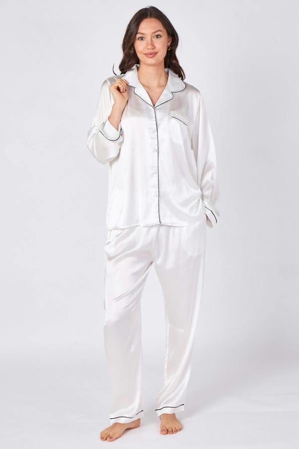 Woman wearing white satin pajamas on a white background