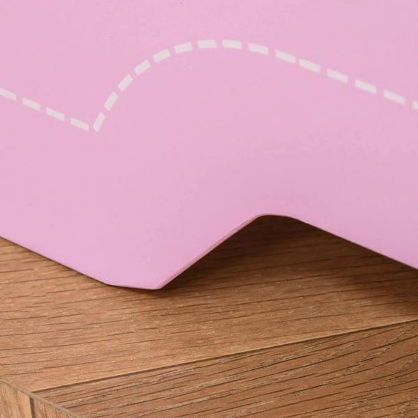 Close-up of pink bed frame corner with rounded edge and decorative cutout shape