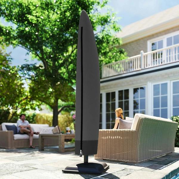 Black cantilever umbrella cover on stand base near outdoor sofa set
