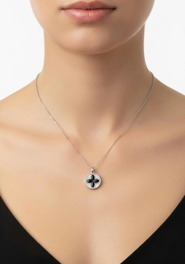 Necklace with a clover pendant on a model against a neutral background