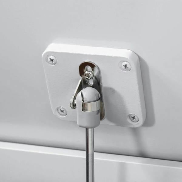 Close-up of grey toy box hinge hardware with safety rod connection bracket.
