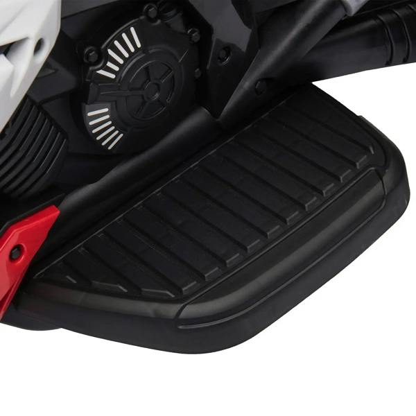 Black footrest on a kids electric ride-on motorcycle, with red side trim